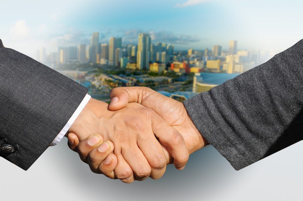 shaking hands, handshake, skyline-3213665.jpg